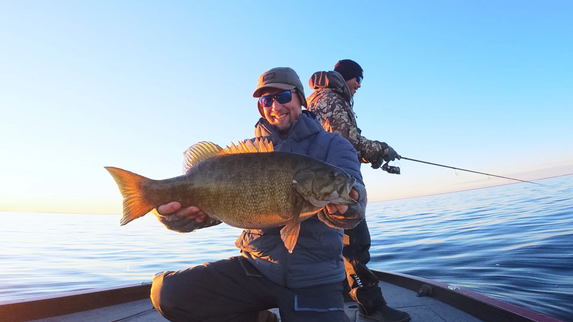 Angler showcasing a smallmouth bass on Mille Lacs Lake