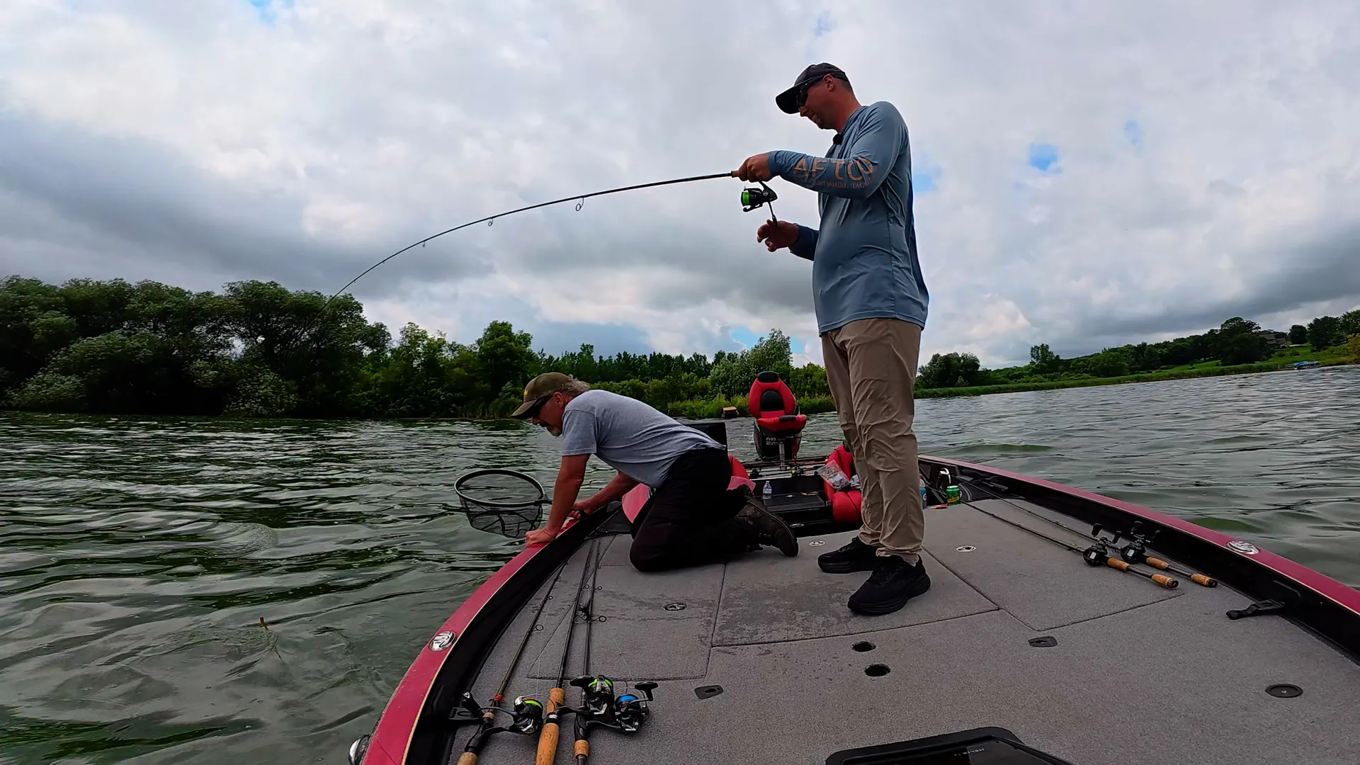 2 bass anglers catching smallmouth on boat