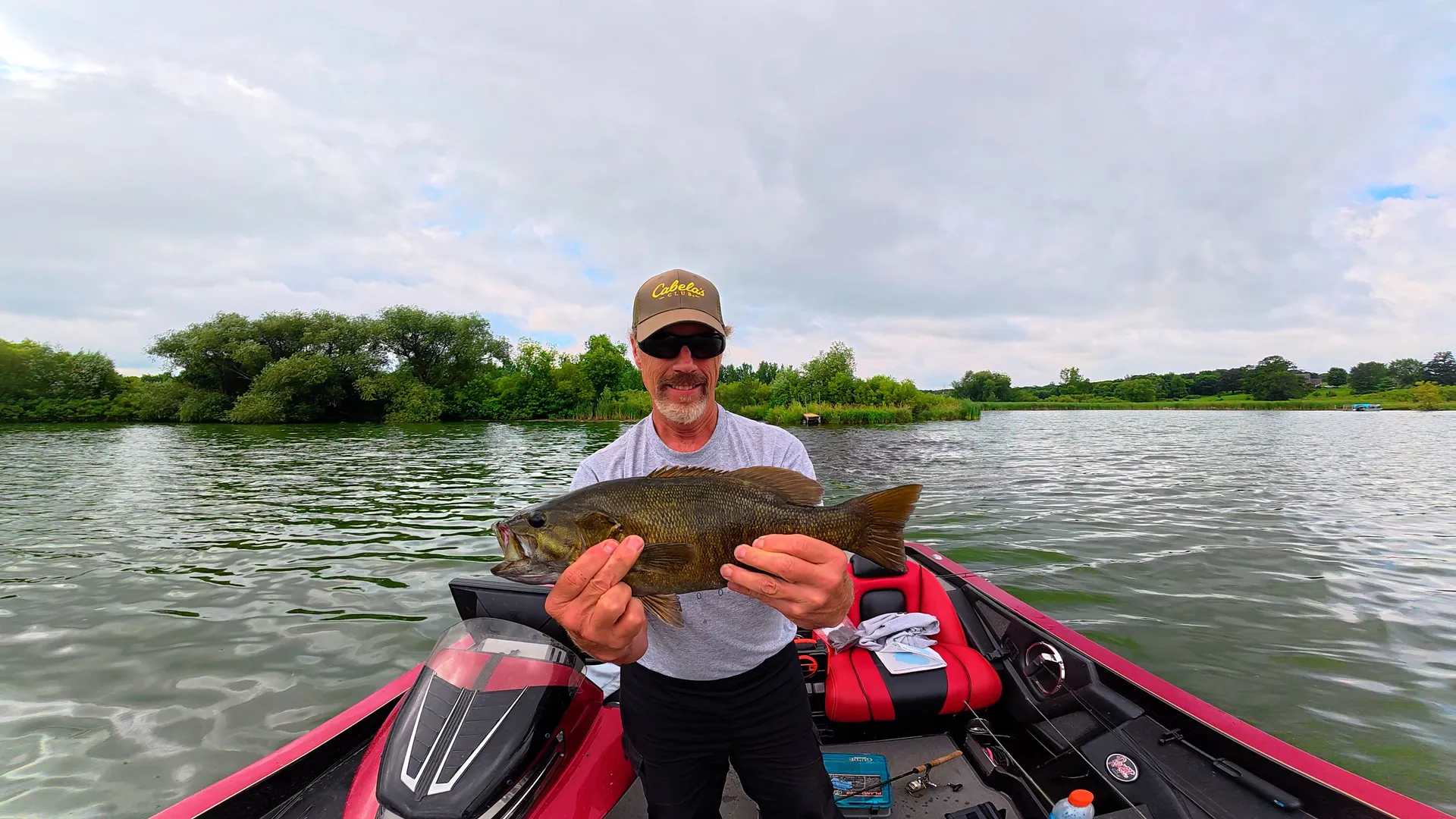 angler holding a caught smallmouth bass